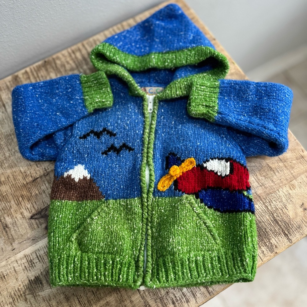 Blue and Green Knit Sweater Handmade In Ecuador. Beautiful airplane and clouds.
